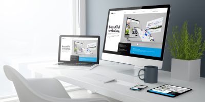 3d rendering of desktop with all devices showing builder website. All screen graphics are made up.
